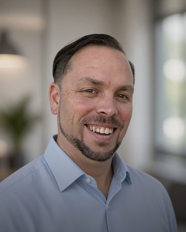 Rob Stevens, smiling, in a light blue shirt